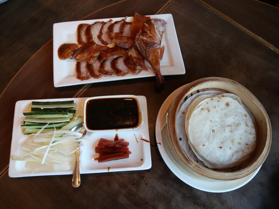 Thin slices of crisp Peking duck skin and meat