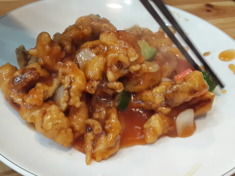 Glossy sweet and sour pork pieces with a light crisp coating